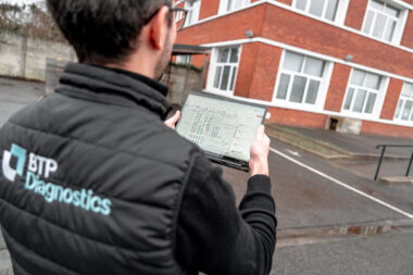 Technicien réalisant un DPE collectif sur un immeuble en copropriété avec relevé des données énergétiques